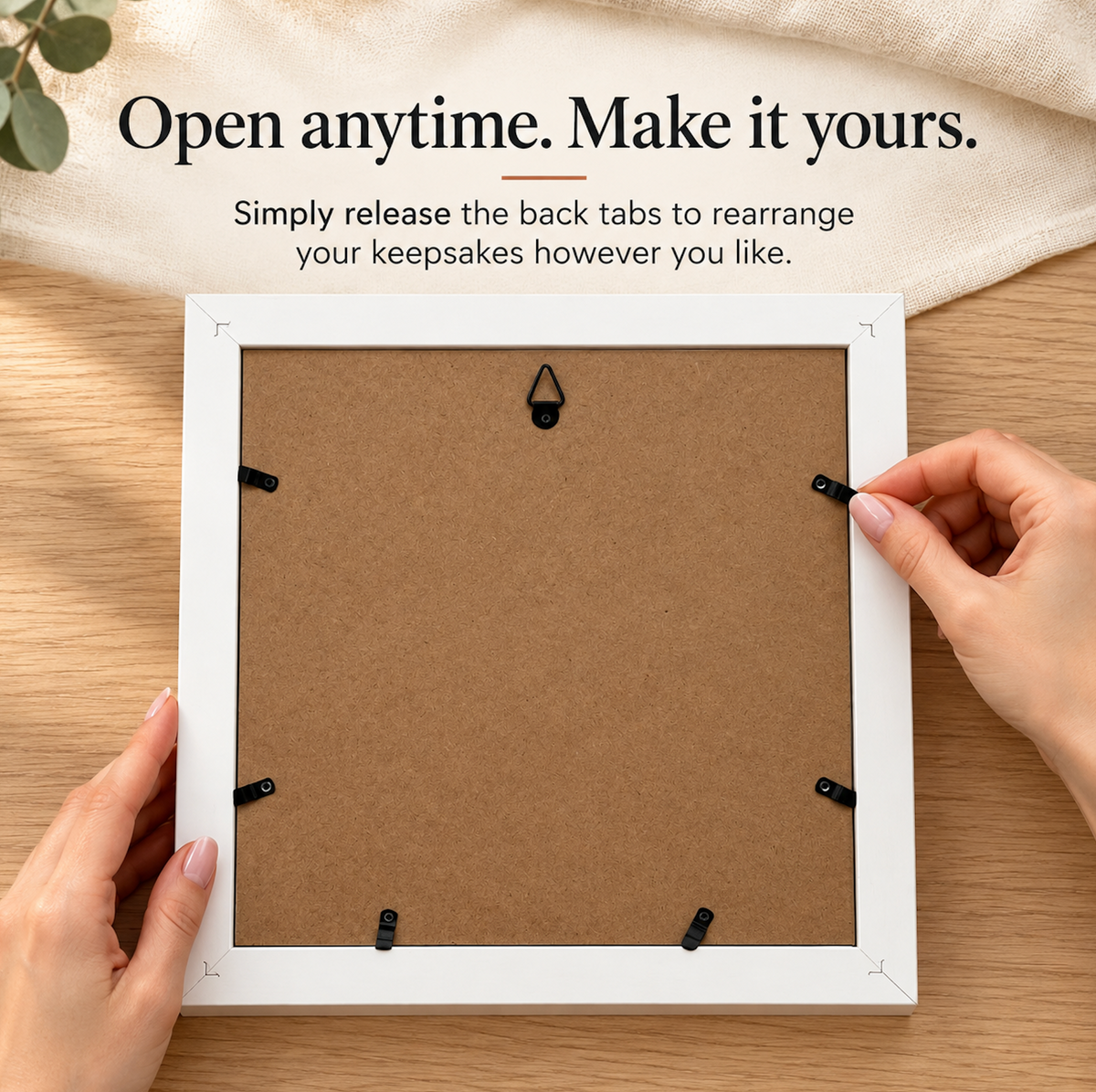 Back panel of the Wandersake Memory Box showing the release tabs and hanging hook, printed with the words Open anytime. Make it yours.